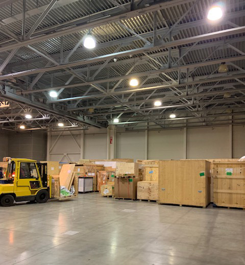 A forklift truck driving event equipment into a truck